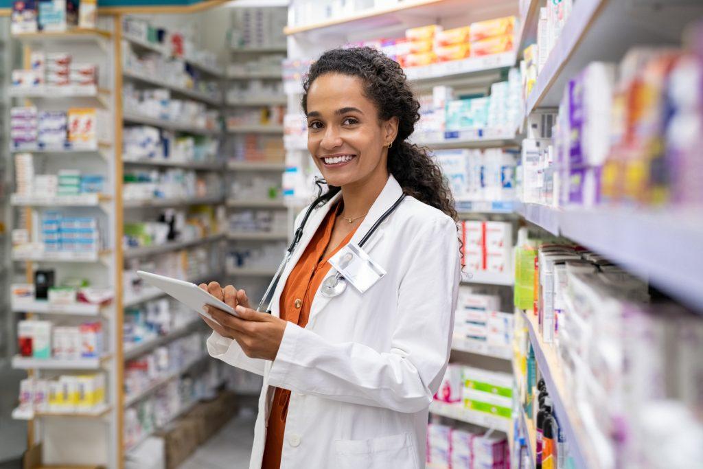 female pharmacist smiling in pharmacy